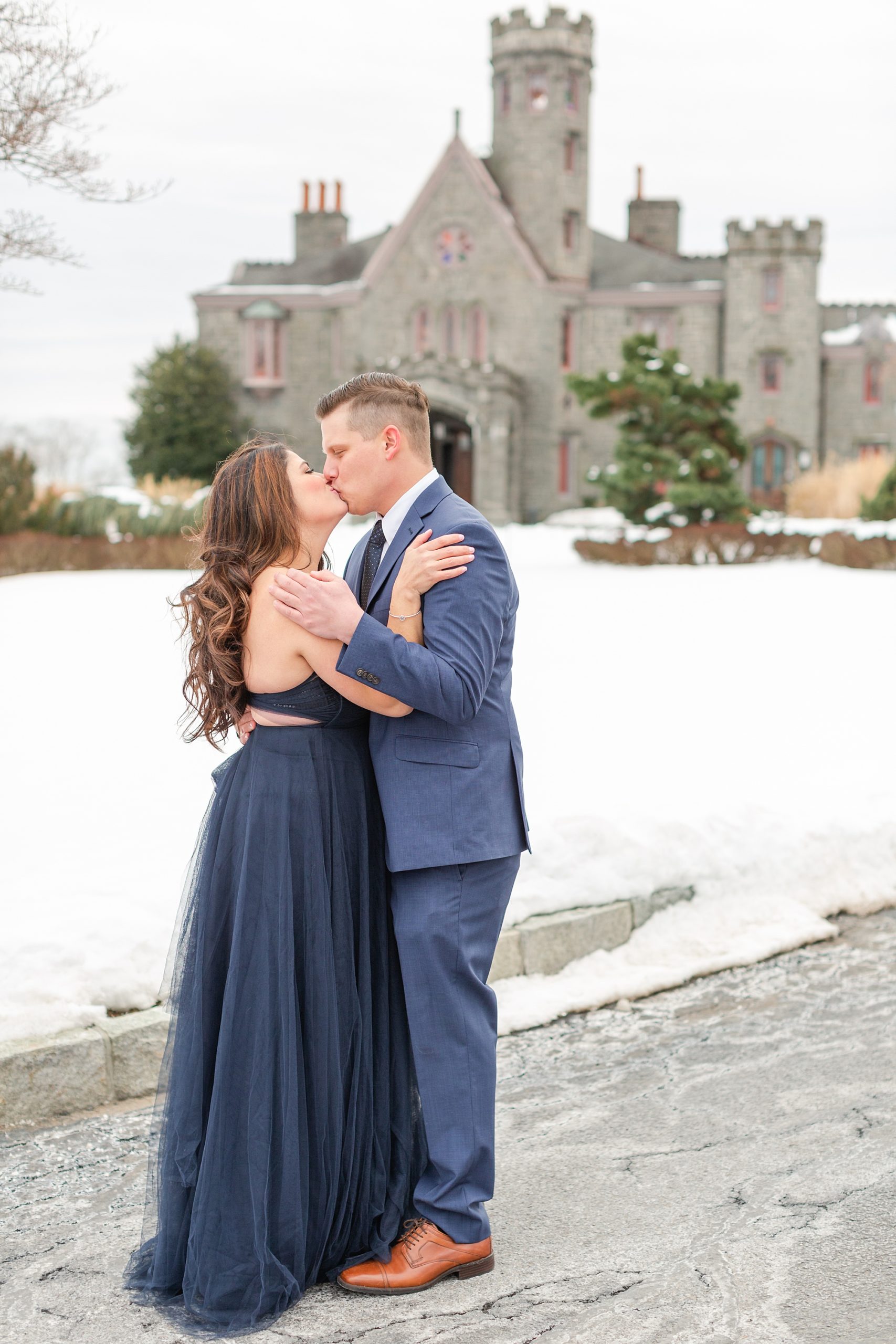 Couple kisses in front of Whitby Castle during Engagement Session