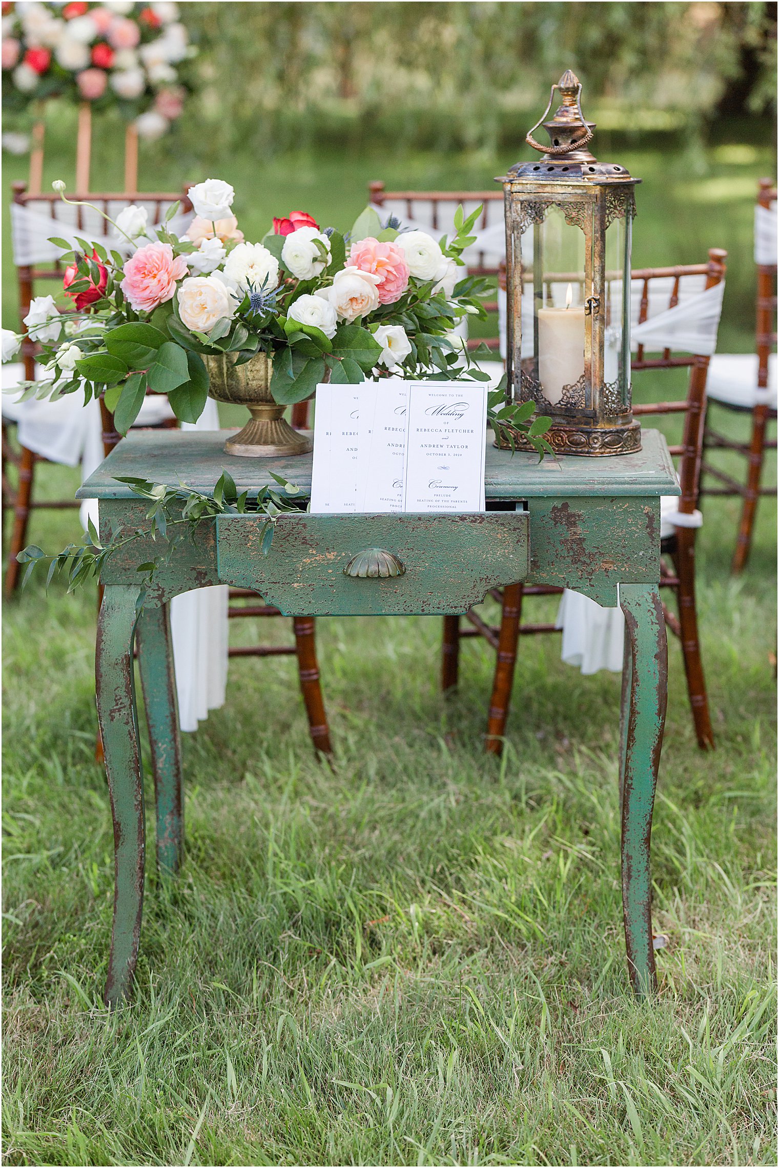 wedding programs on antiqued table with flowers