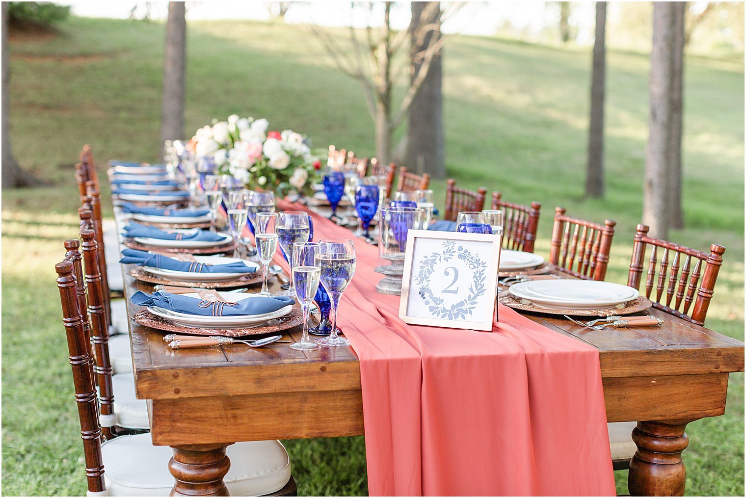 blue table setting and floral centerpieces at wedding editorial 