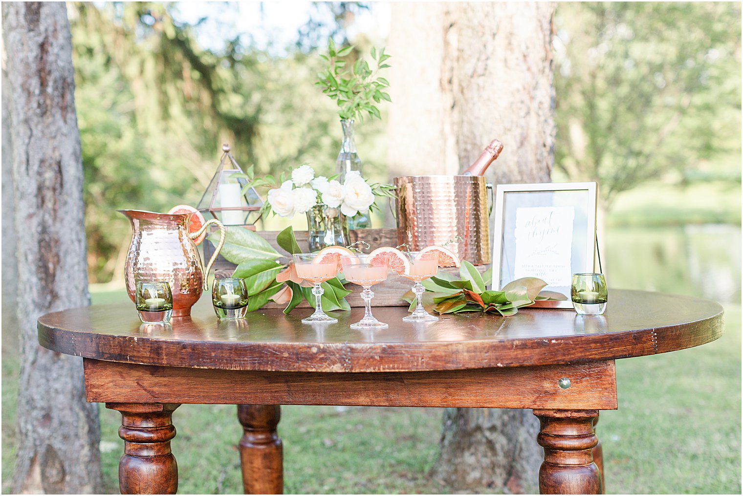pink wedding cocktails set up outside on table