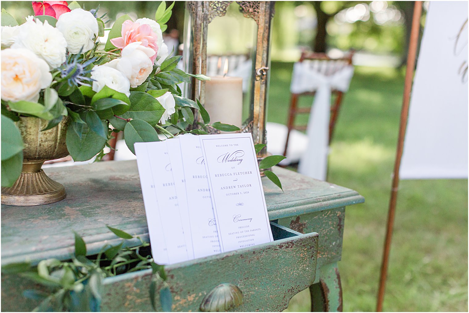 wedding programs on antiqued table with flowers