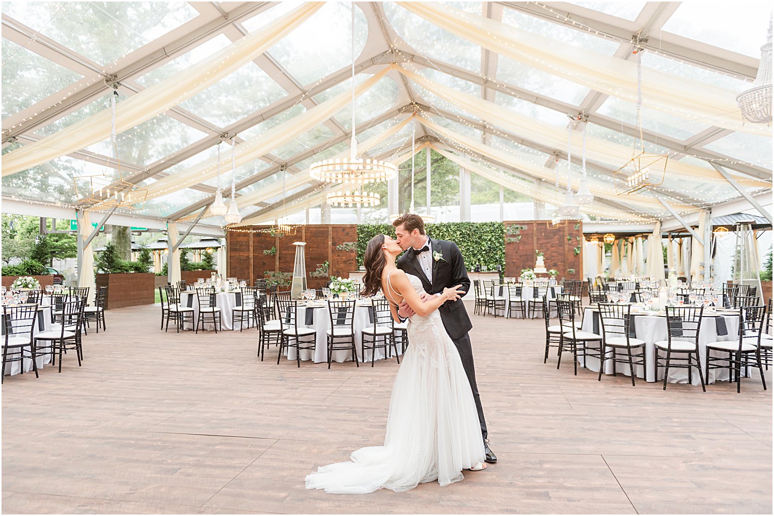 Bride + Groom kiss in empty reception tent before reception at Philadelphia PA Wedding at Franklin Square  