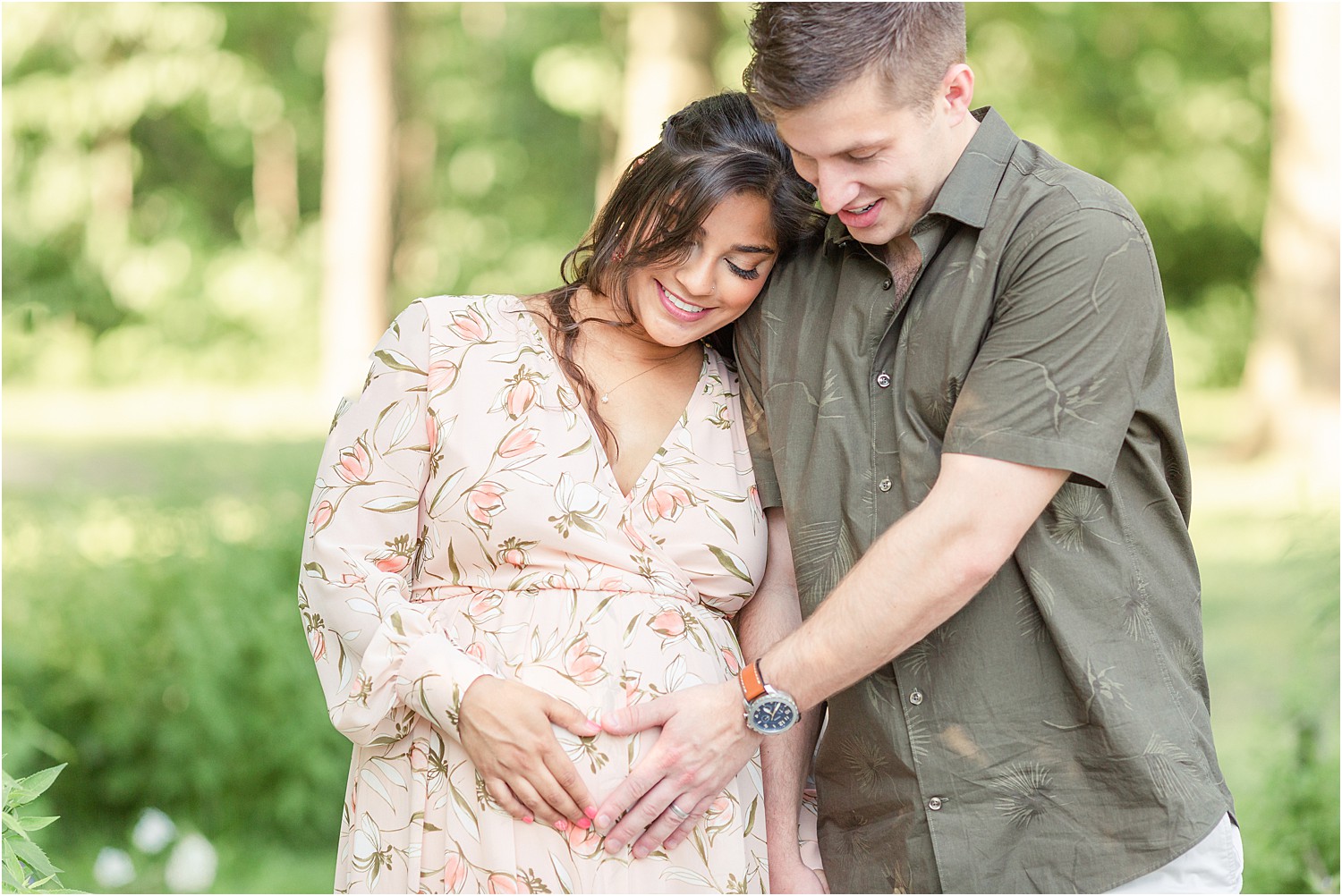 couple feels mom's belly for baby