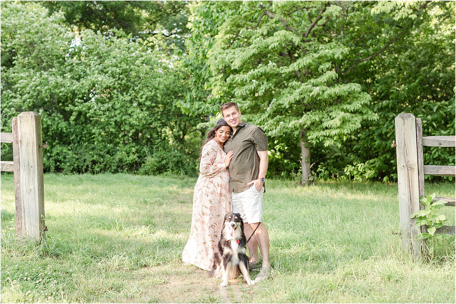 couple in field with their dog for maternity photos