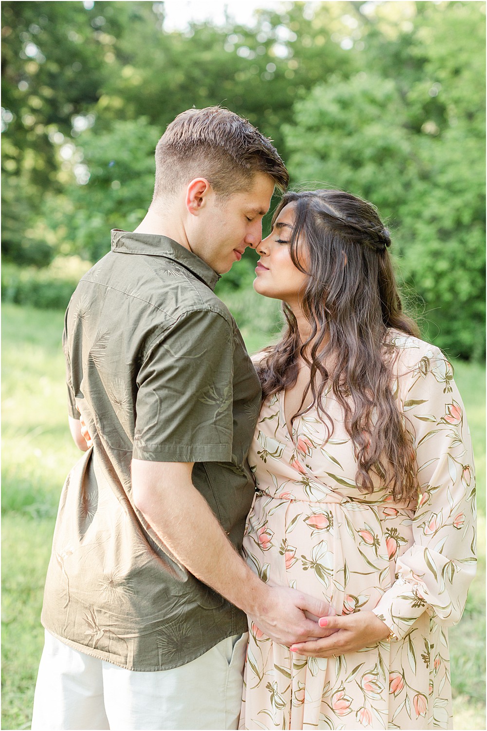 wife looks up at husband during outdoor PA maternity session