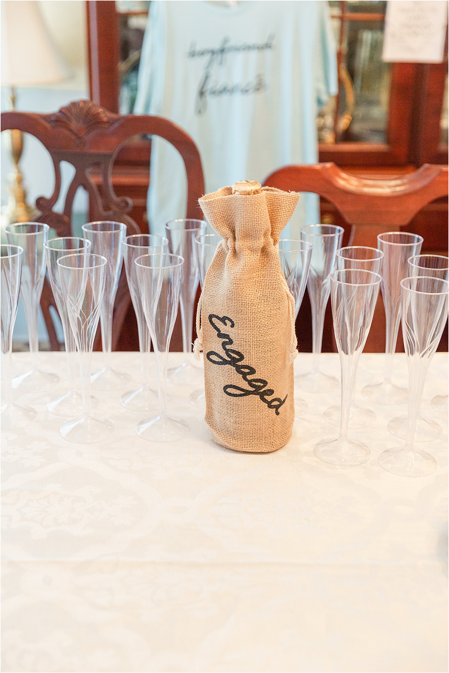 Bottle of champagne in burlap Engaged bag