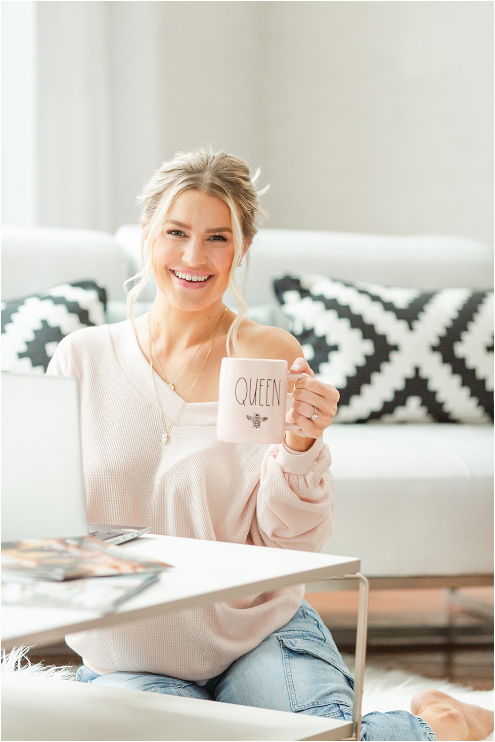 successful business owner holds up Queen bee mug during branding photos