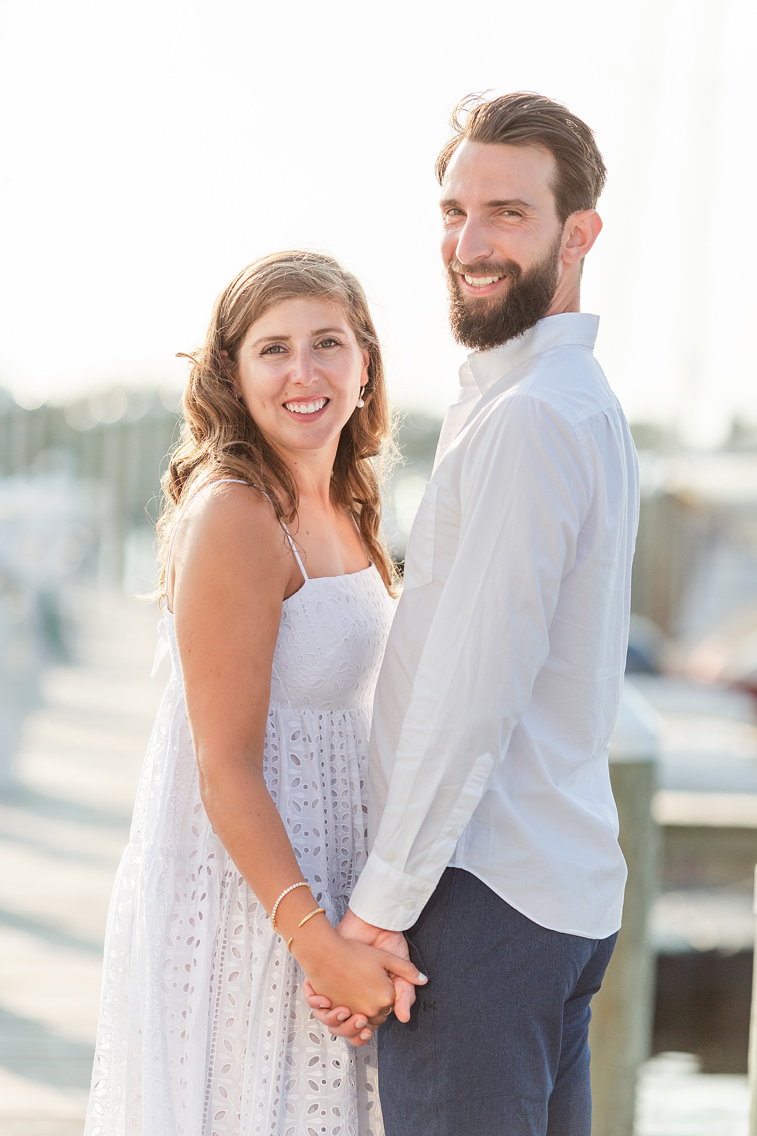 couple on boat docks in NJ for engagement photos