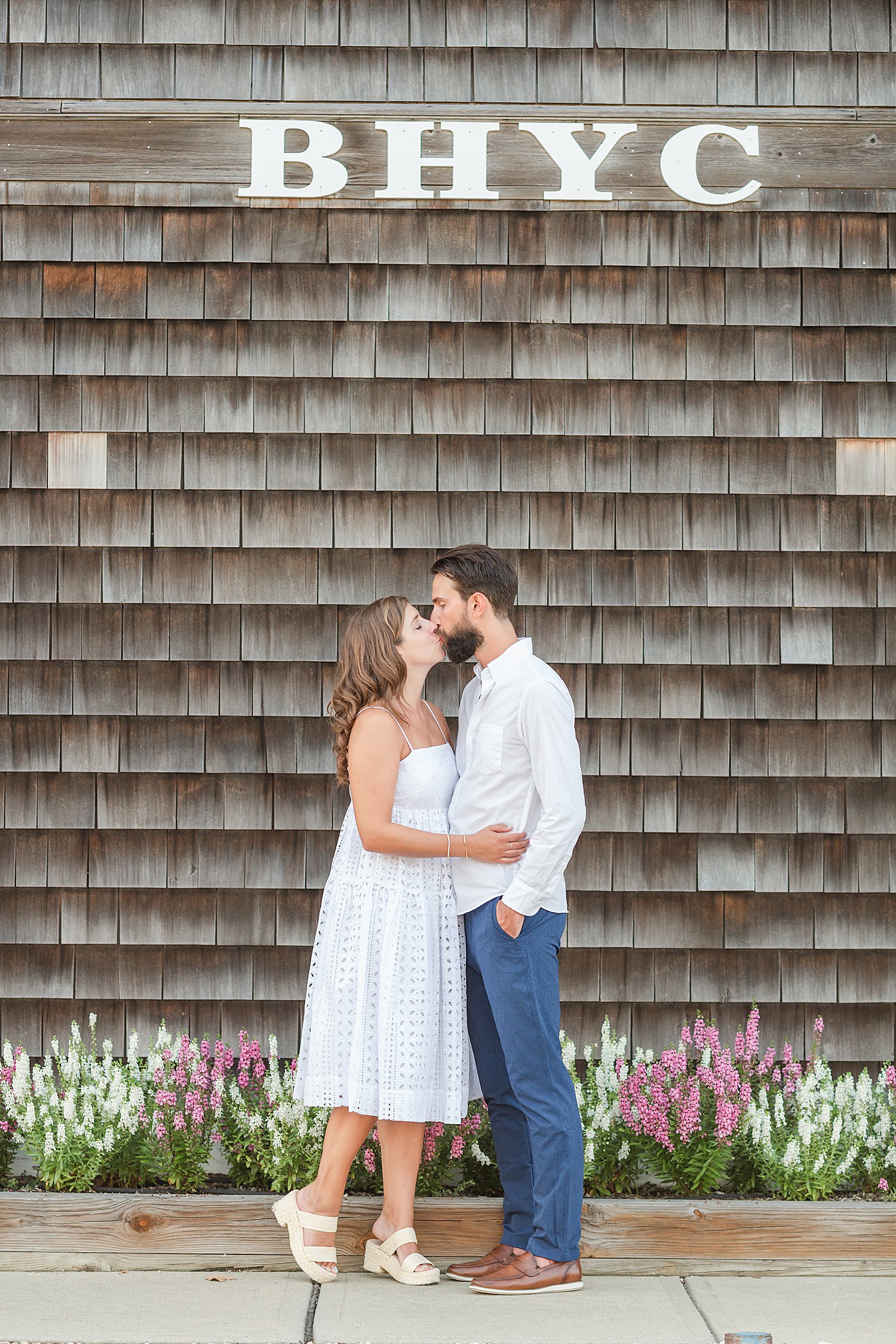 couple stand near Bayhead Yacht Club during Engagement Session