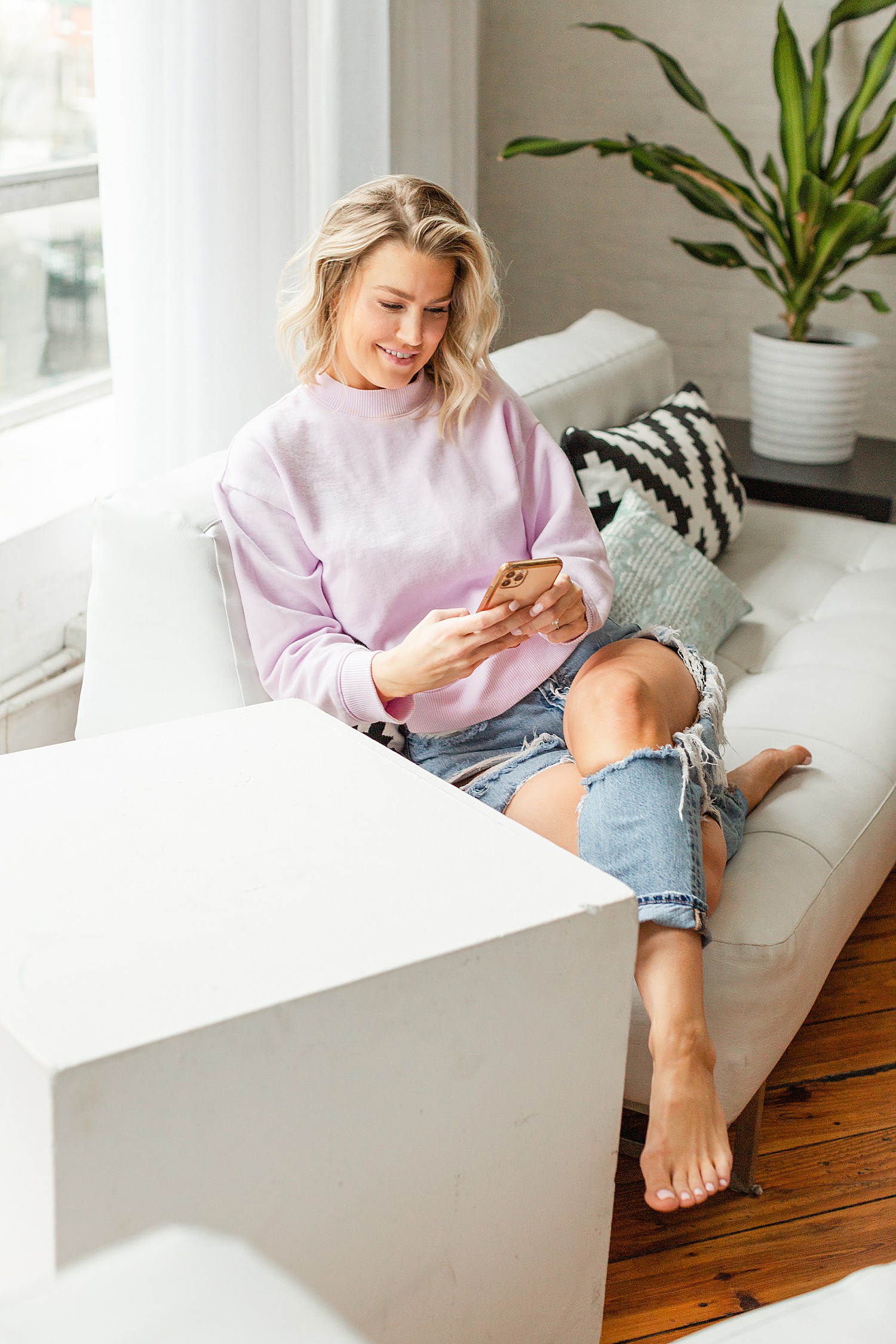 woman in casual clothes looks at phone for work during branding session