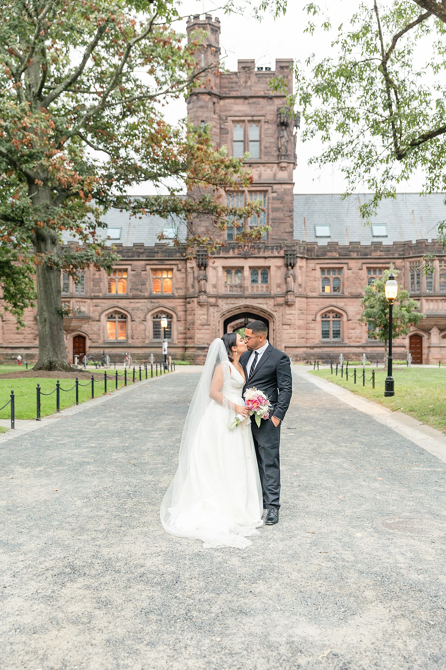 husband and wife kiss outside Princeton university NJ