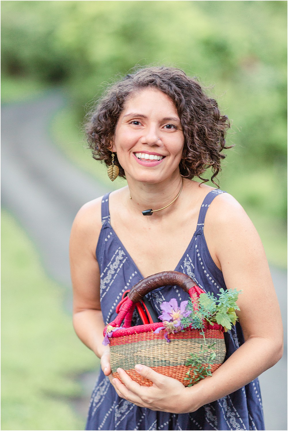 Female business owner holding basket of herbs used for wellness