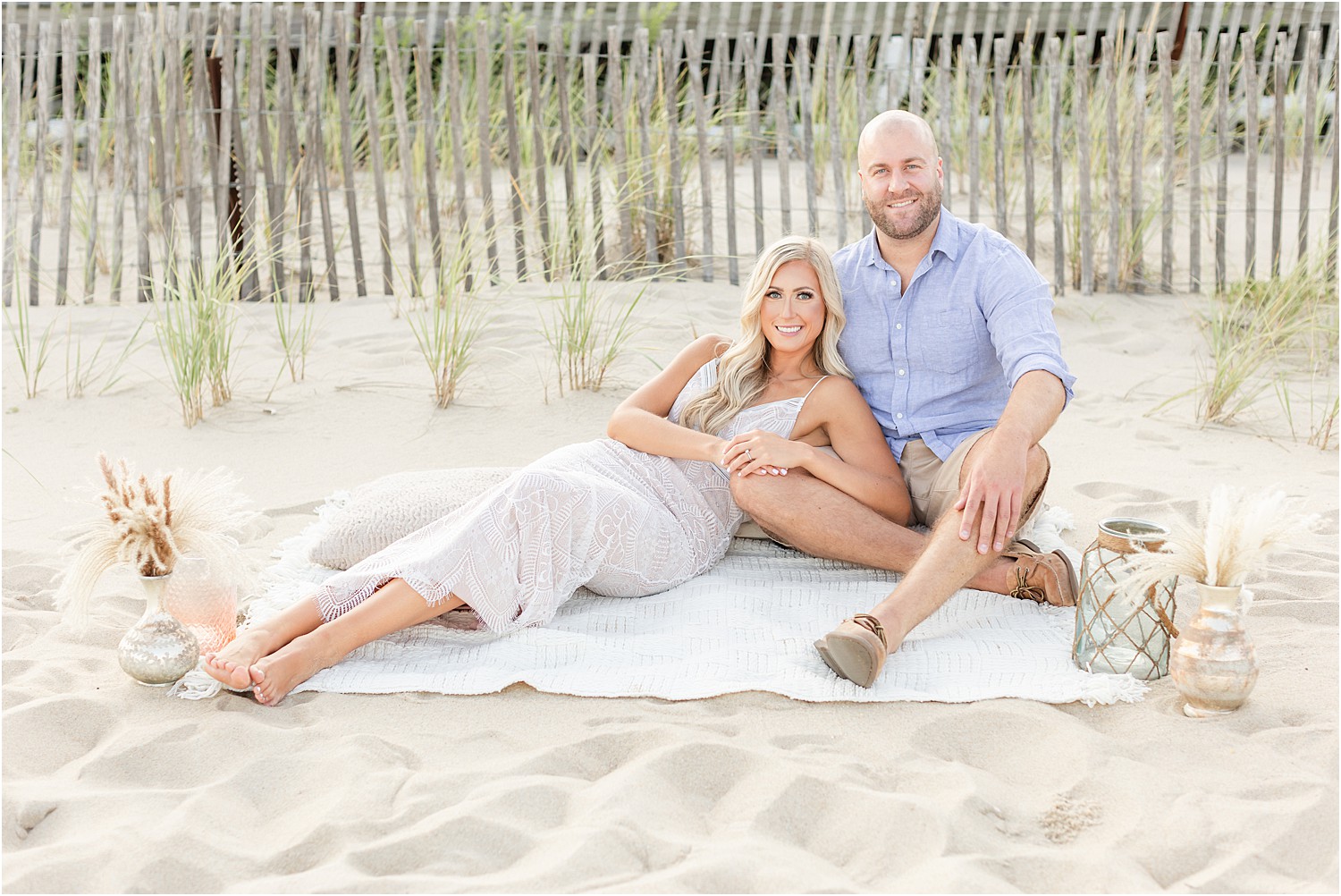 engaged couple relax at Belmar beach during engagement session