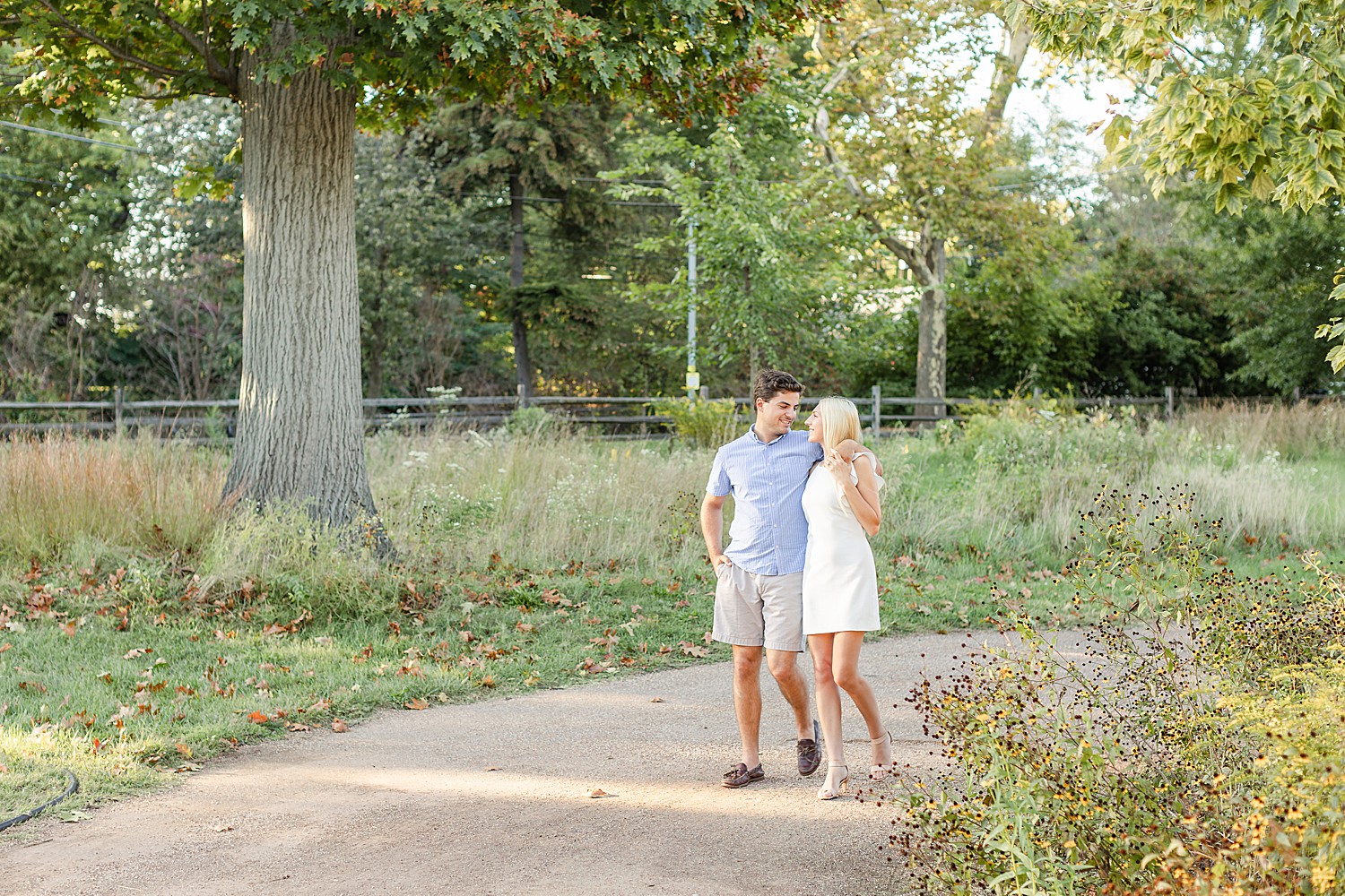 couple walks down walking path at Bartram’s Garden in PA