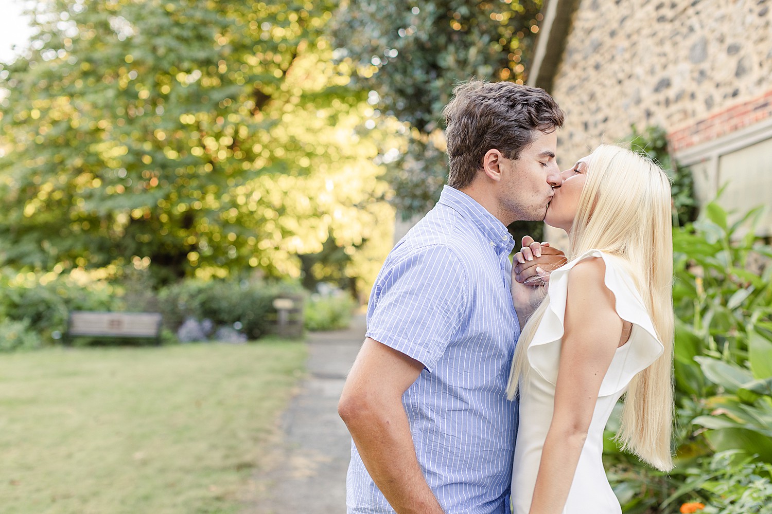 couple kiss near during engagement photos