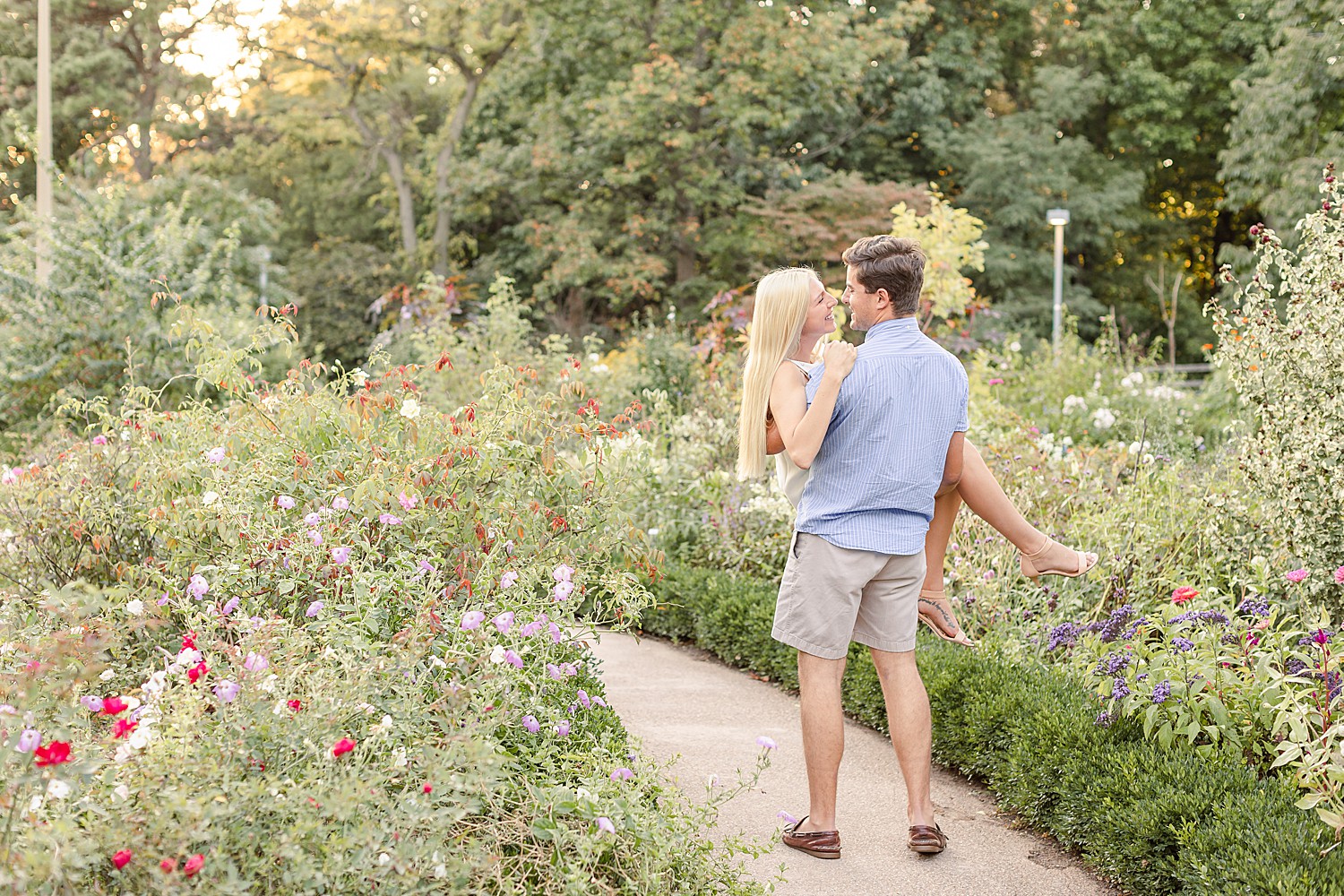 guy lifts up fiance in beautiful garden setting in PA