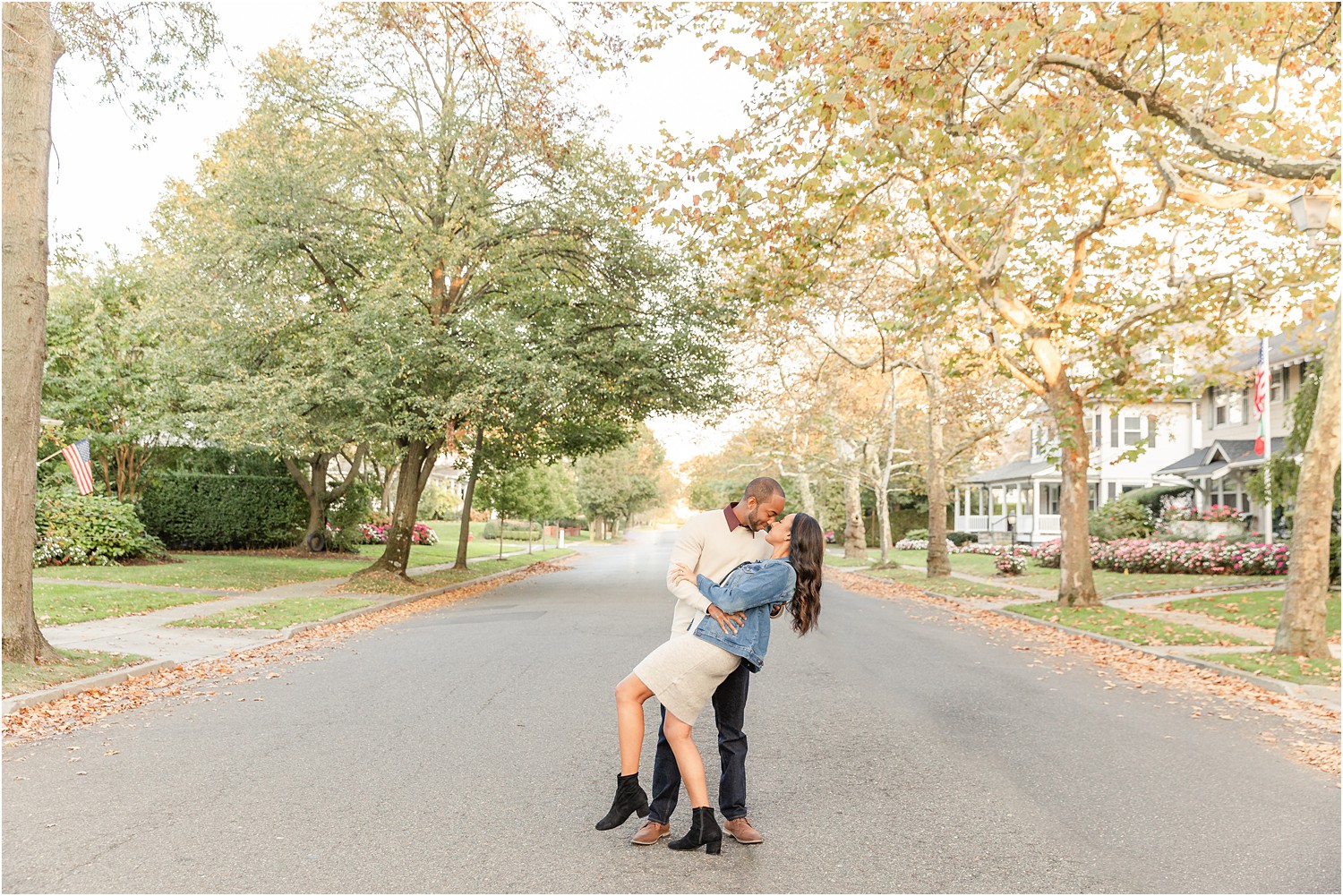 man dips his fiancé in the road of Spring Lake NJ during engagement session