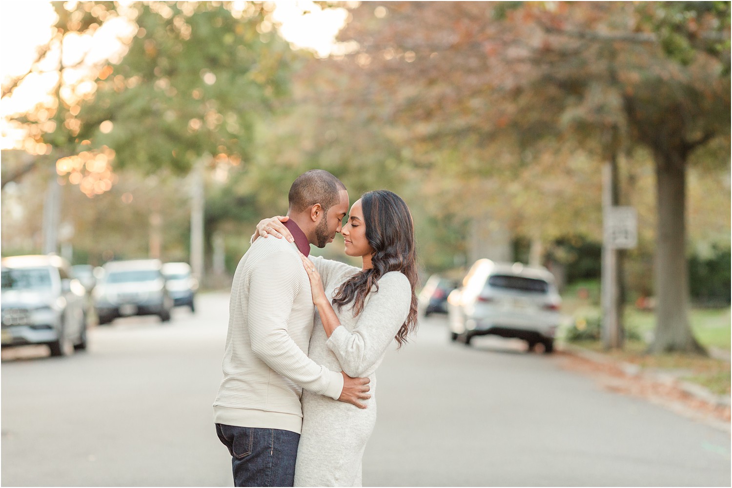 couple lean in together during fall engagement session
