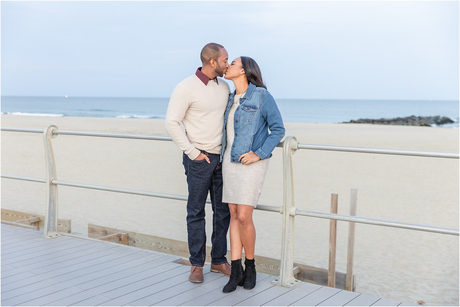 couple kiss at Spring Lake Beach Boardwalk