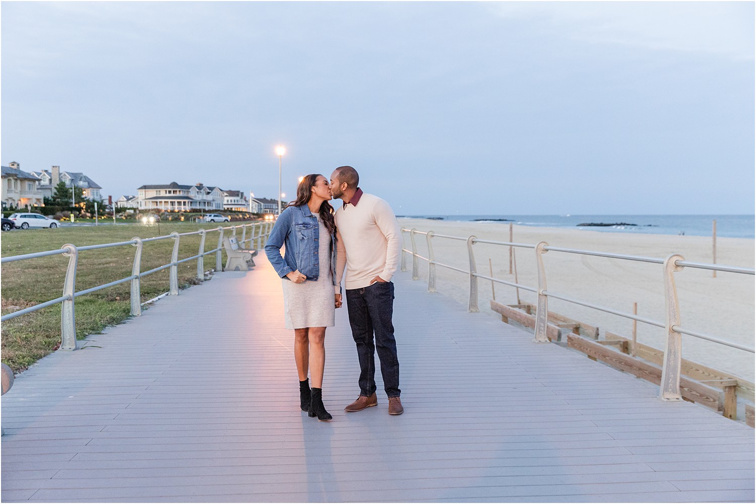 couple kiss during fall engagement session at Spring Lake Beach in NJ