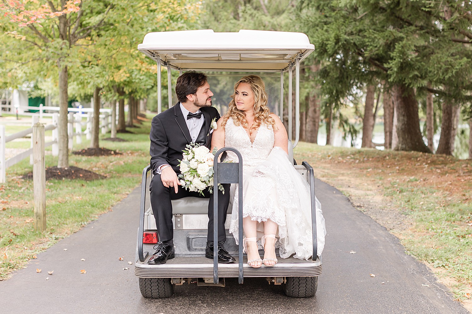 couple look at each other as they ride on golf cart