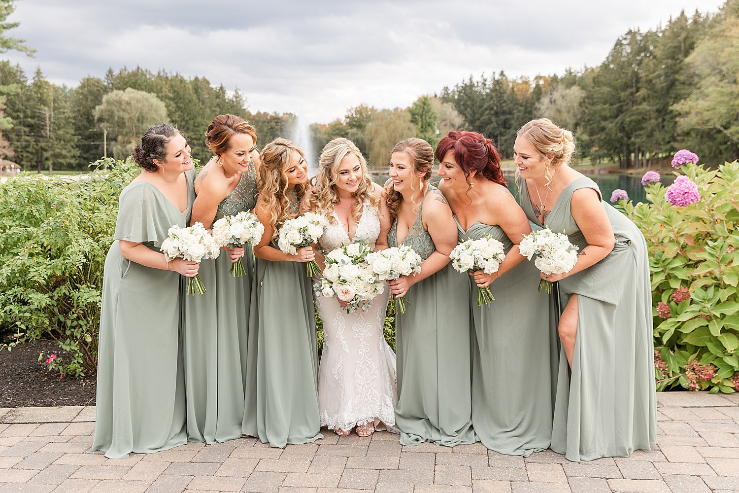 bride and bridesmaids in sage green bridesmaids dresses 