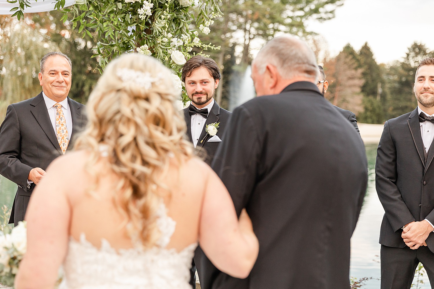 father of the bride hands off bride to groom 