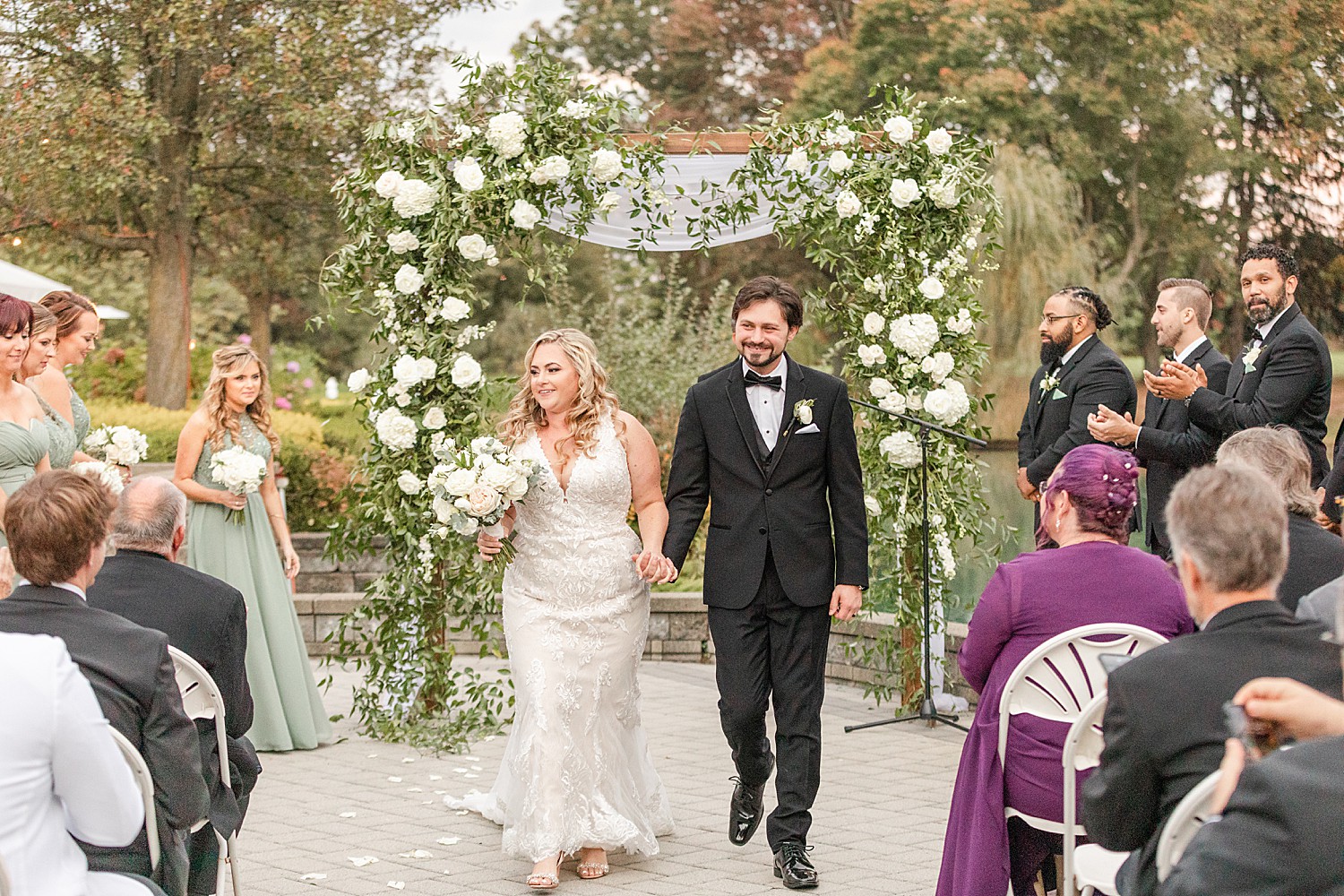 bride and groom walk down aisle together as husband and wife