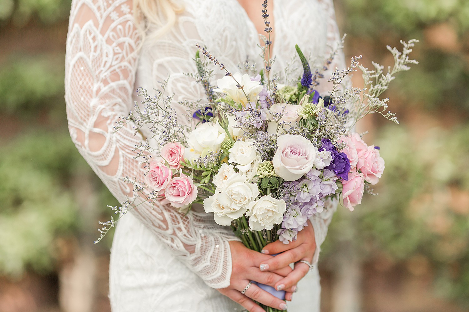 elegant wedding bouquet of light pink and purple and white flowers