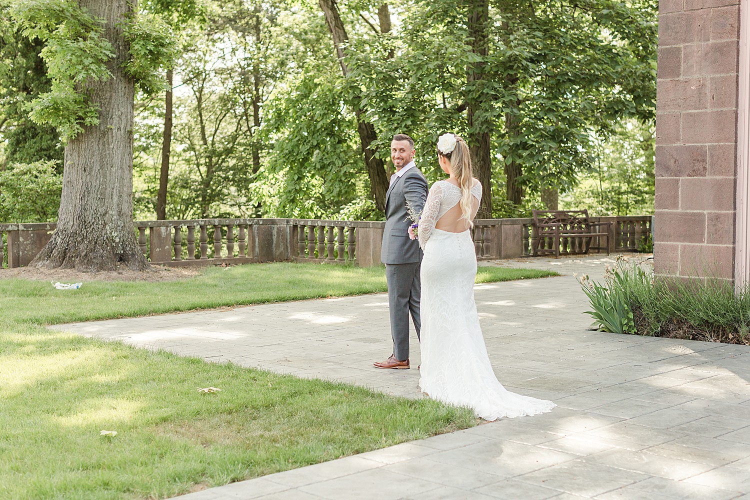bride and groom walk on to patio of mansion at Tyler Gardens