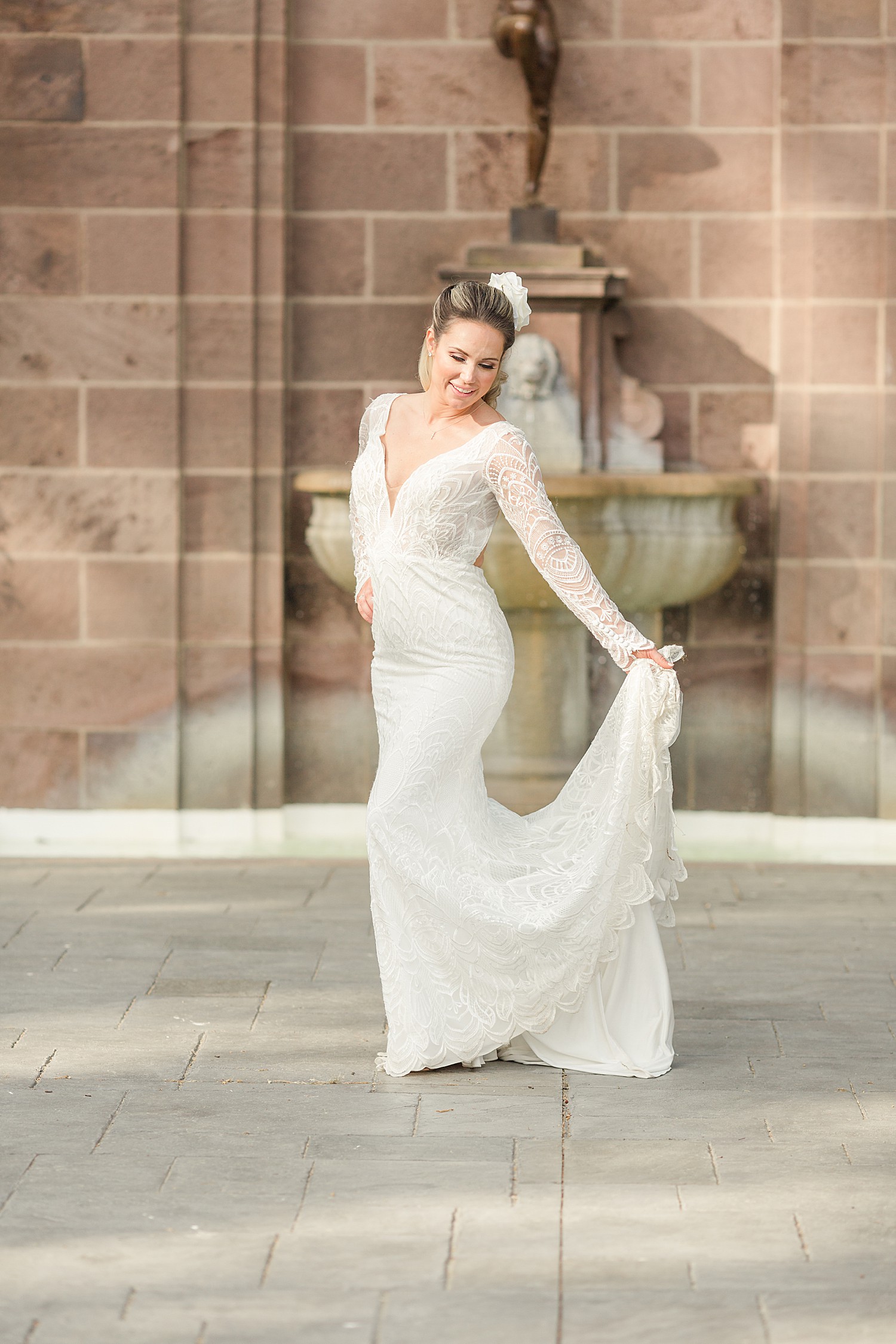 bride twirls and shows of floor length lace wedding gown