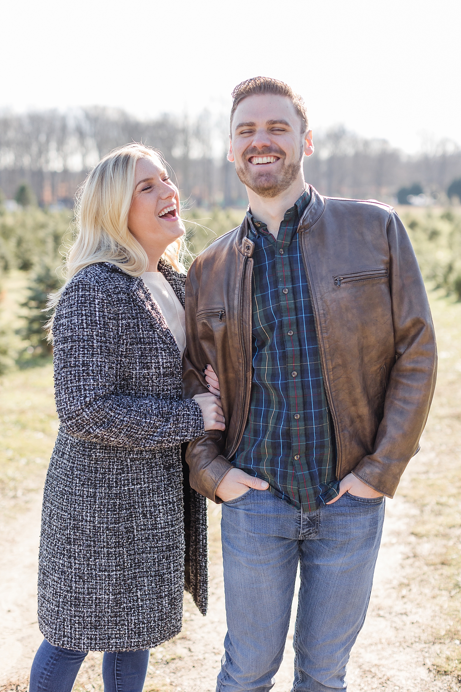 candid engagement photo of couple laughing