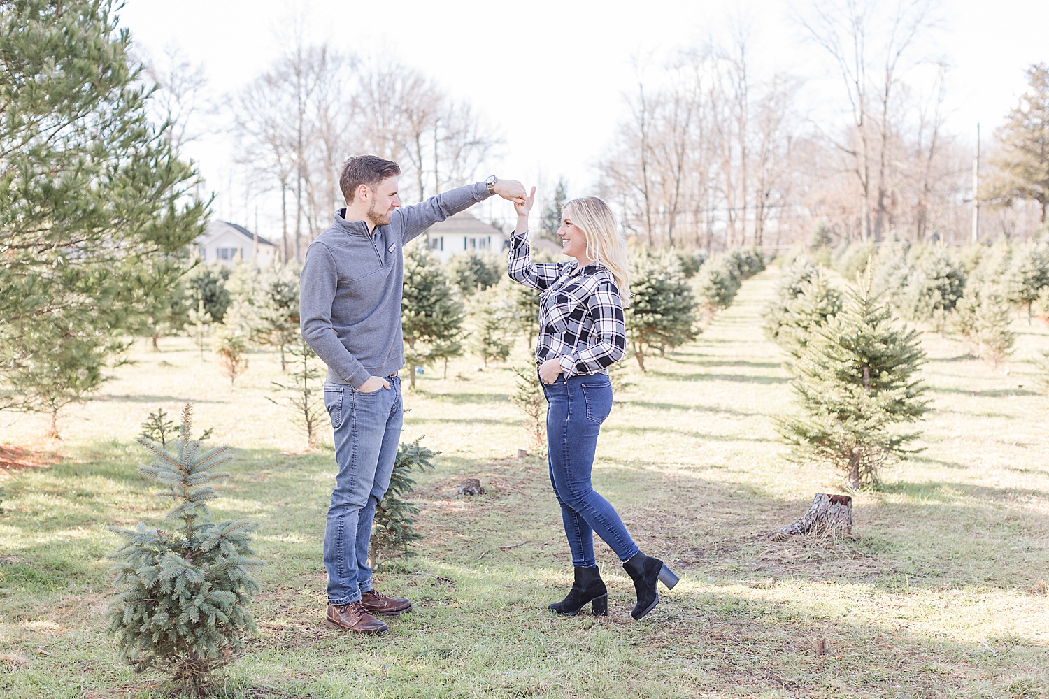 playful engagement photos at Christmas tree farm 