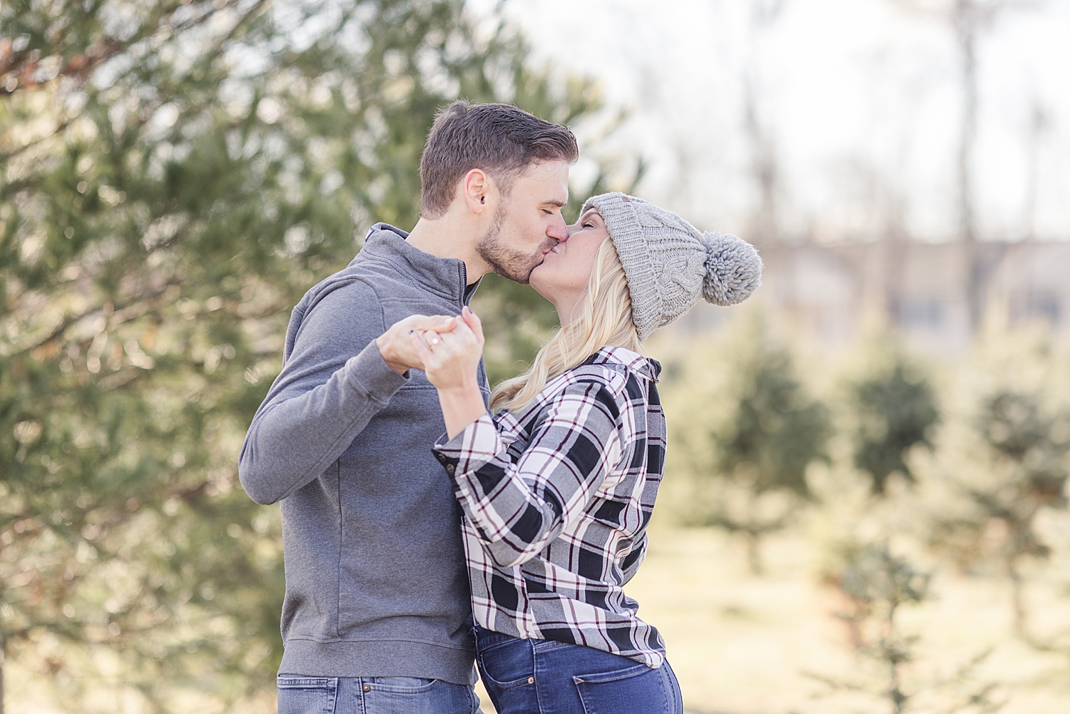 couple kiss during cozy winter engagement session