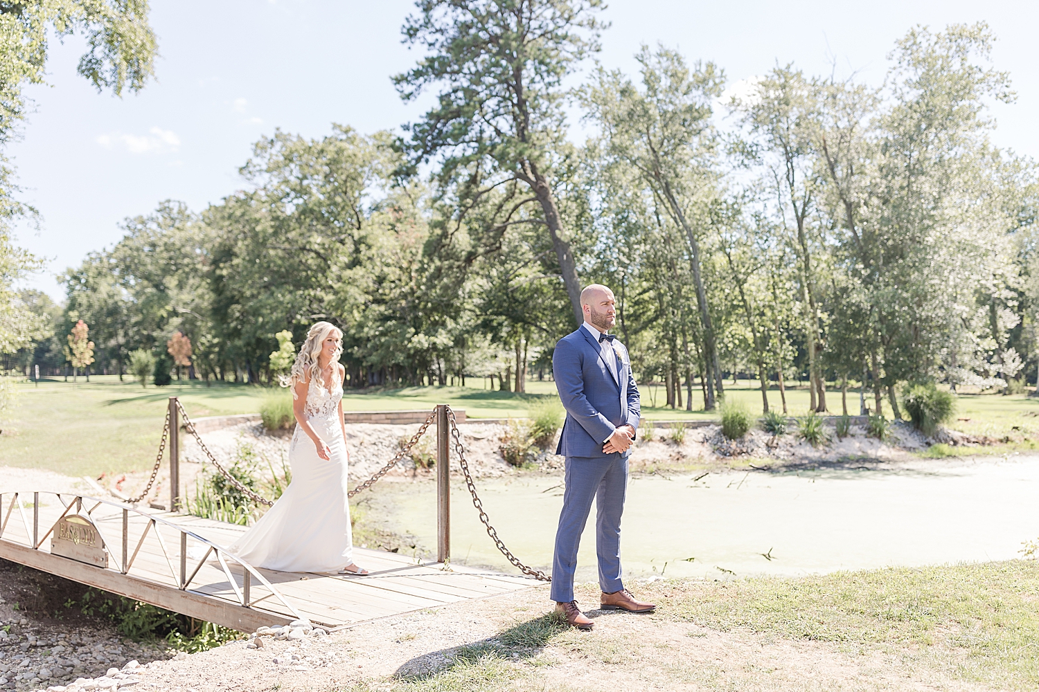 bride walks across bridge for first look