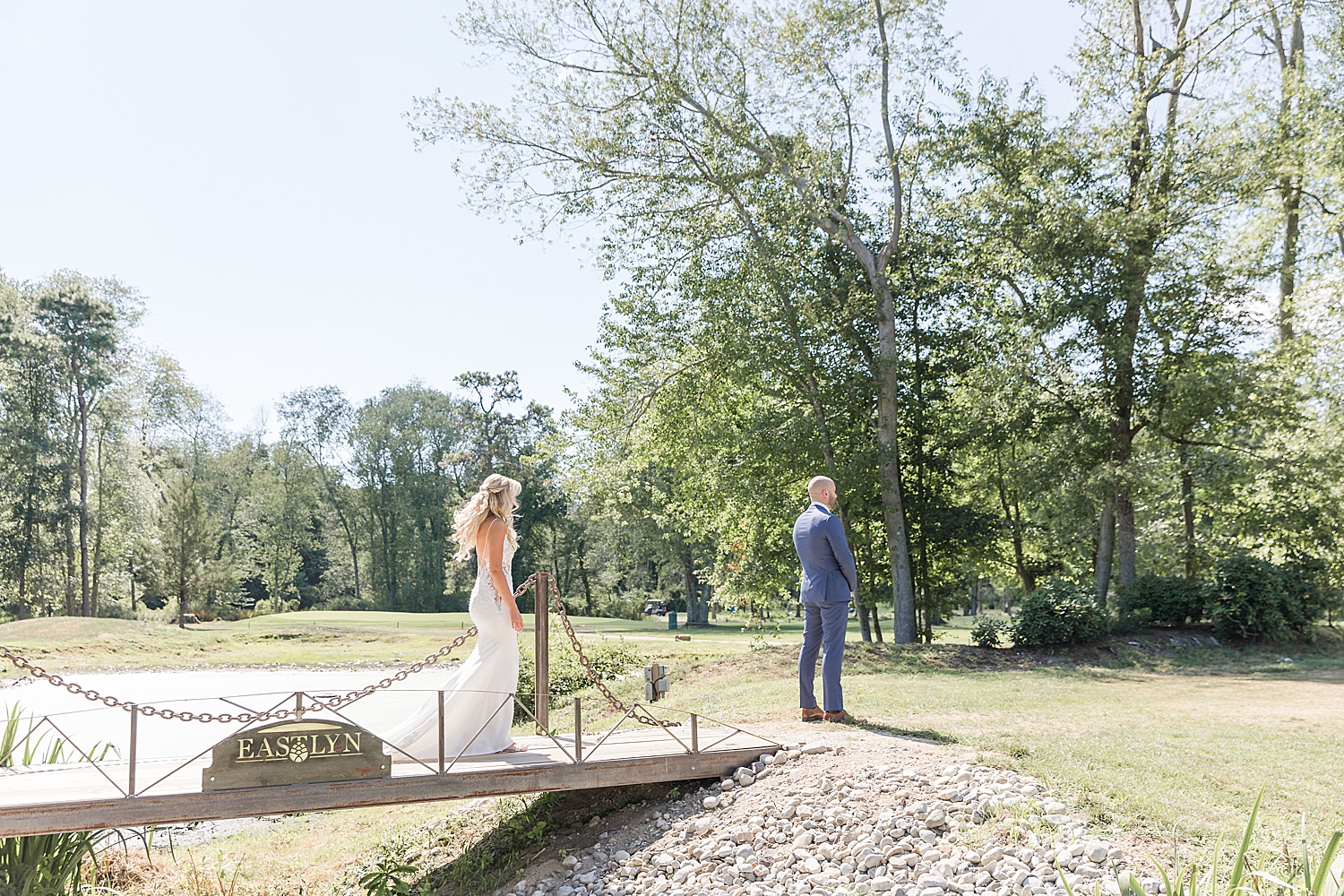 bride walks across bridge to groom