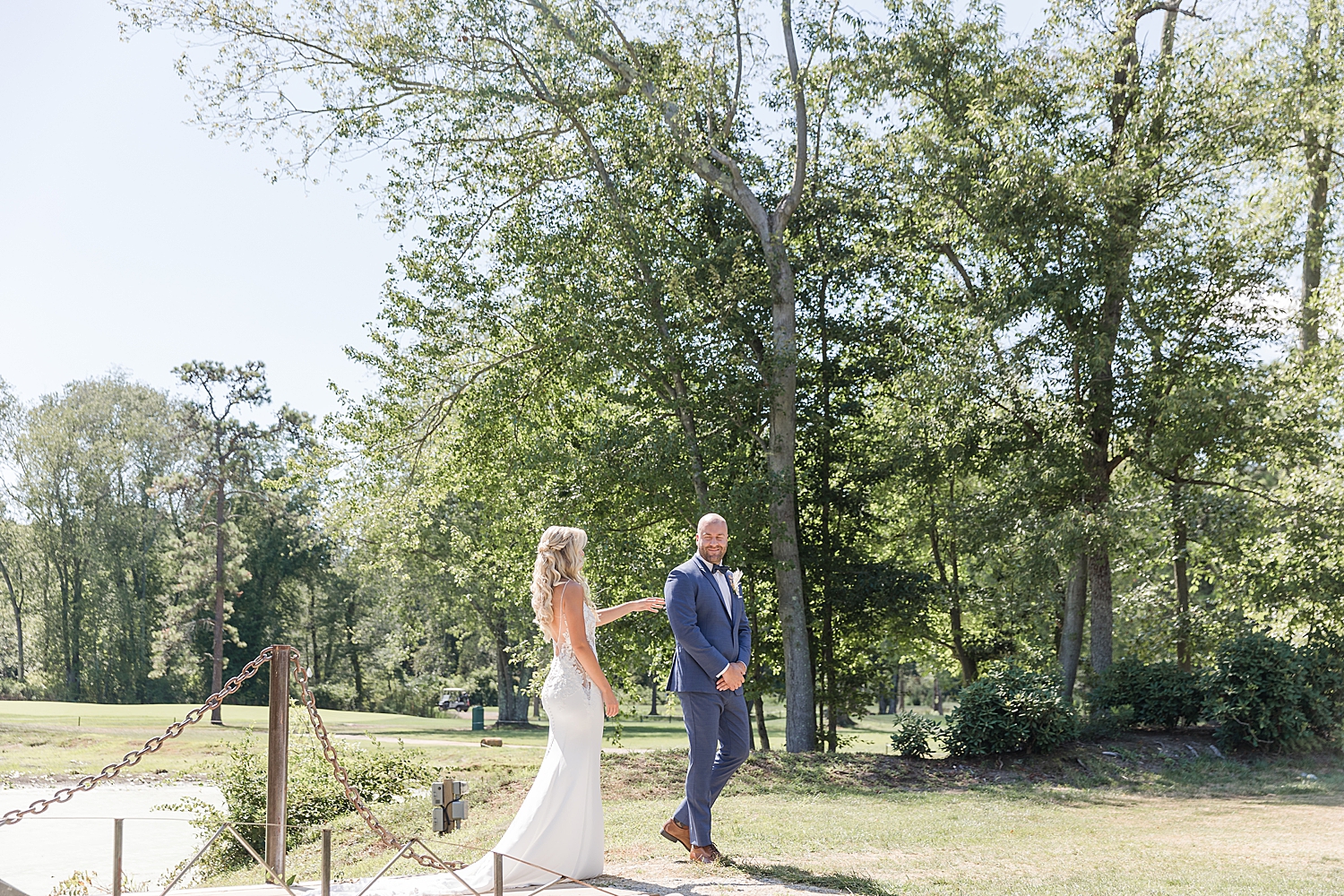 bride taps groom on the shoulder for first look