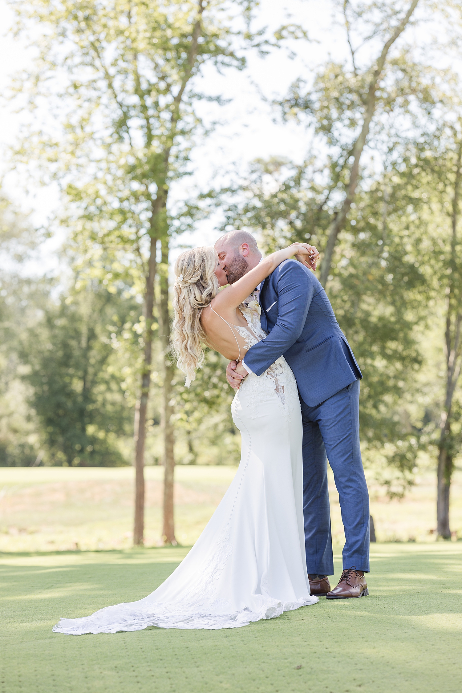 bride and groom kiss on the greens at Eastlyn Golf Course