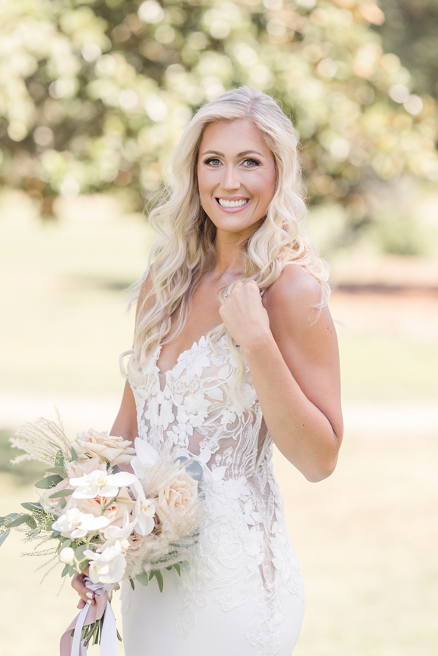 bride with hair down holding bridal bouquet