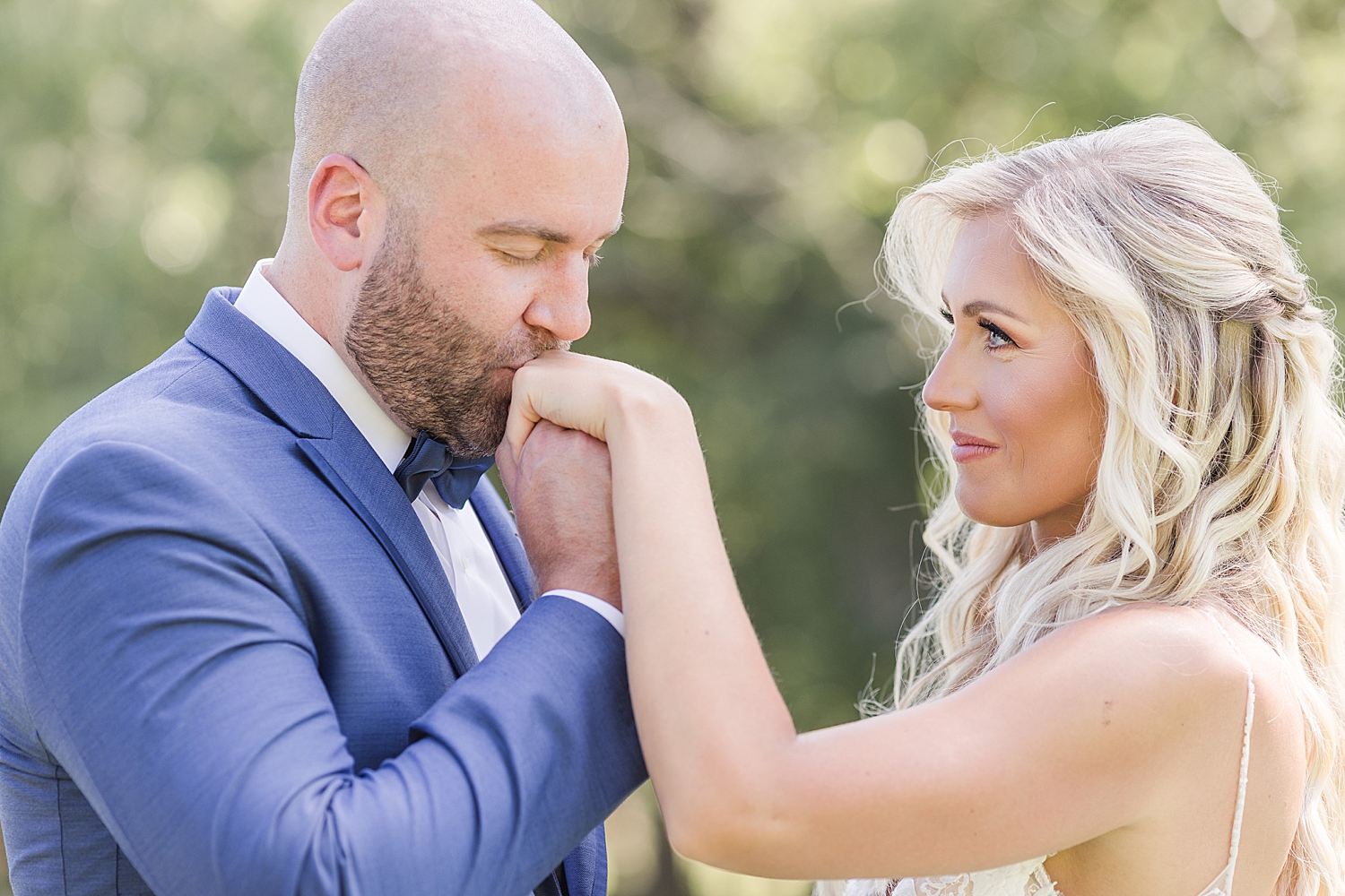 groom kisses bride's hand