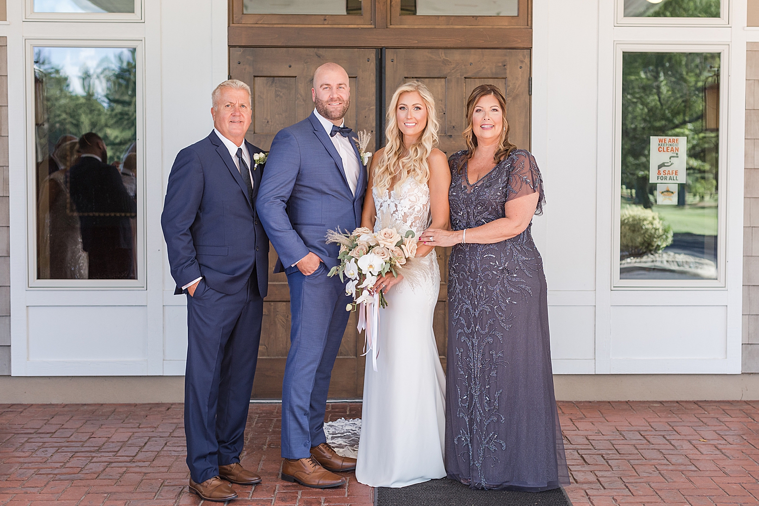 bride and groom with family during Boho Inspired Summer Wedding at Eastlyn Golf Course