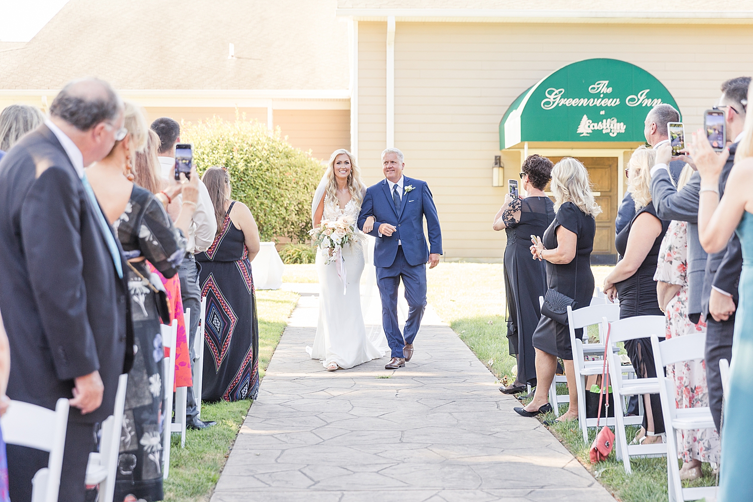 bride walks down the aisle with father