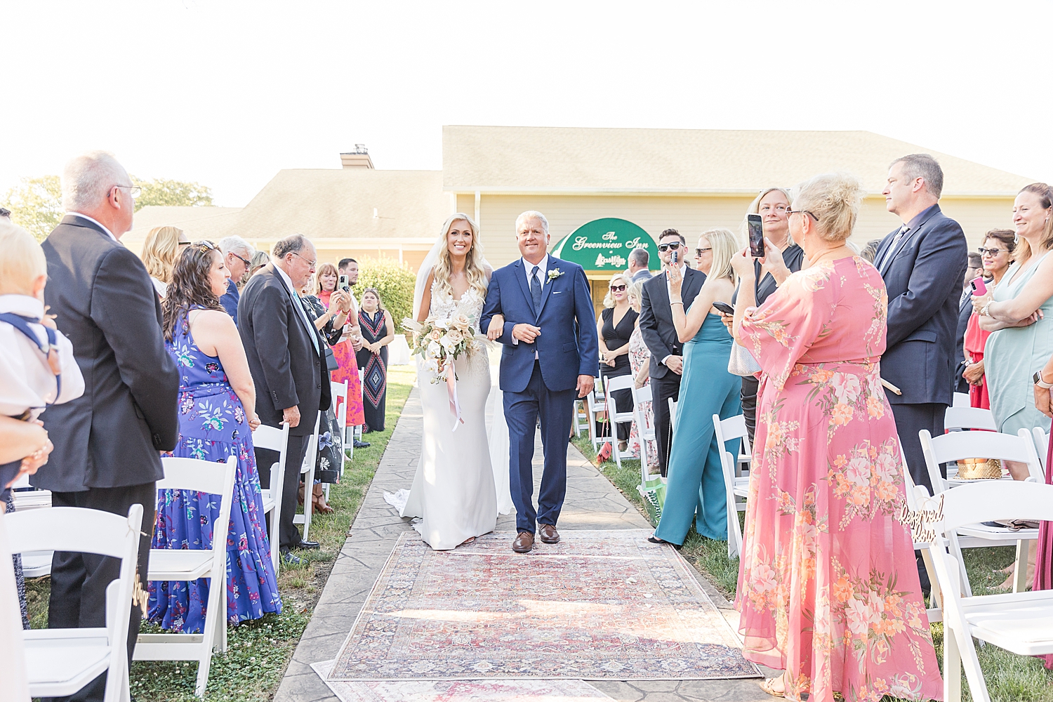 bride and father walk together