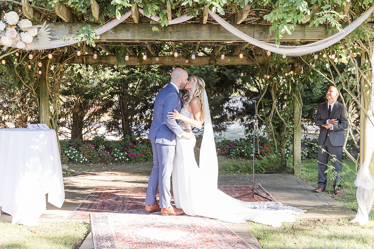 couple kiss at wedding ceremony