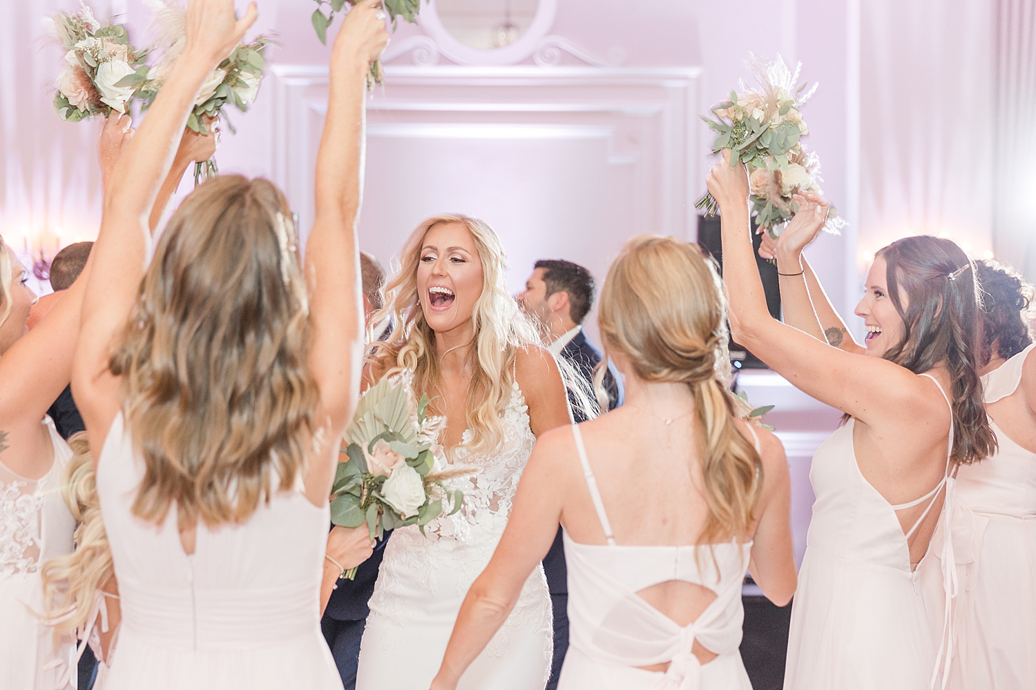 bridesmaids cheer for newlyweds