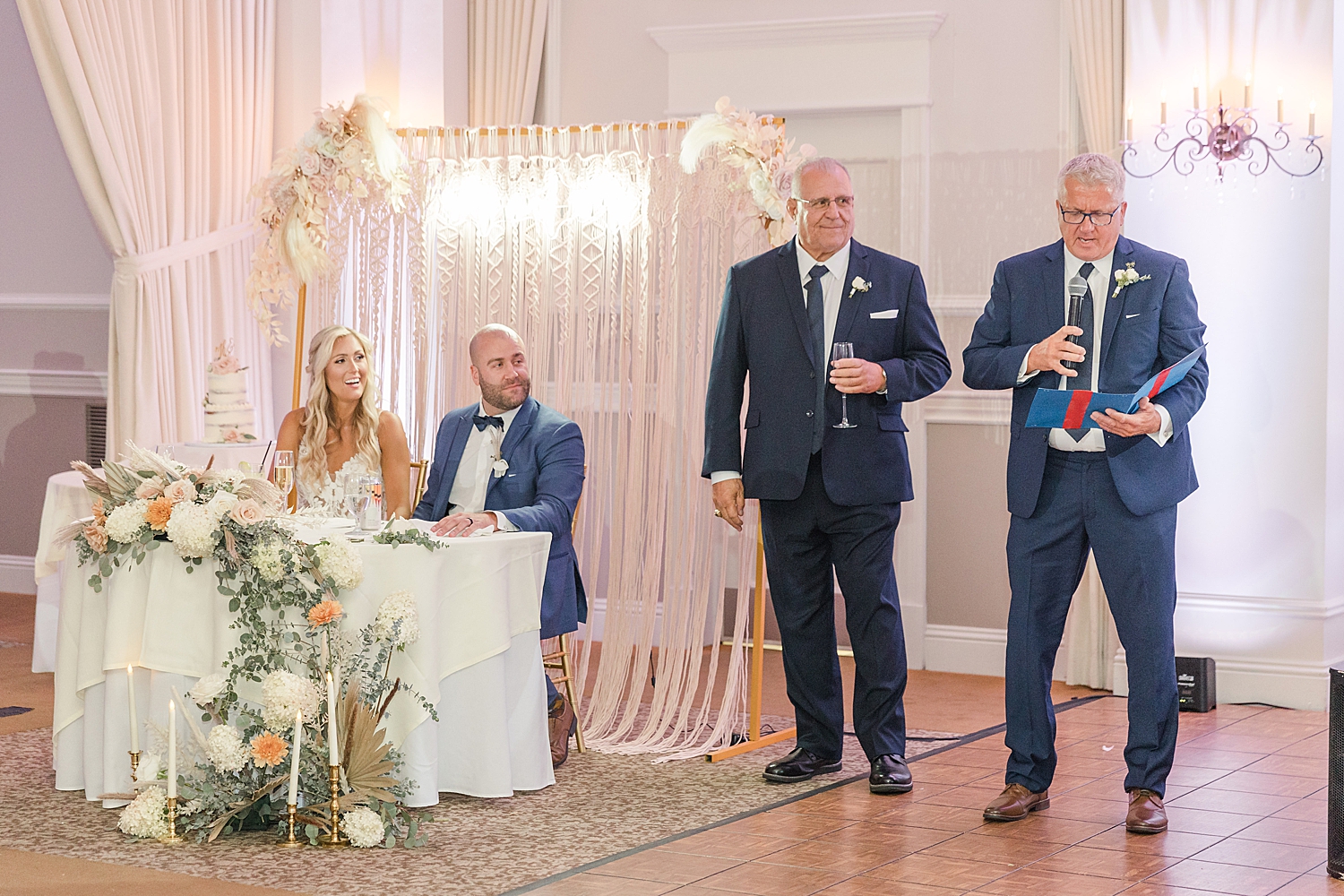 newlyweds listen to wedding toasts