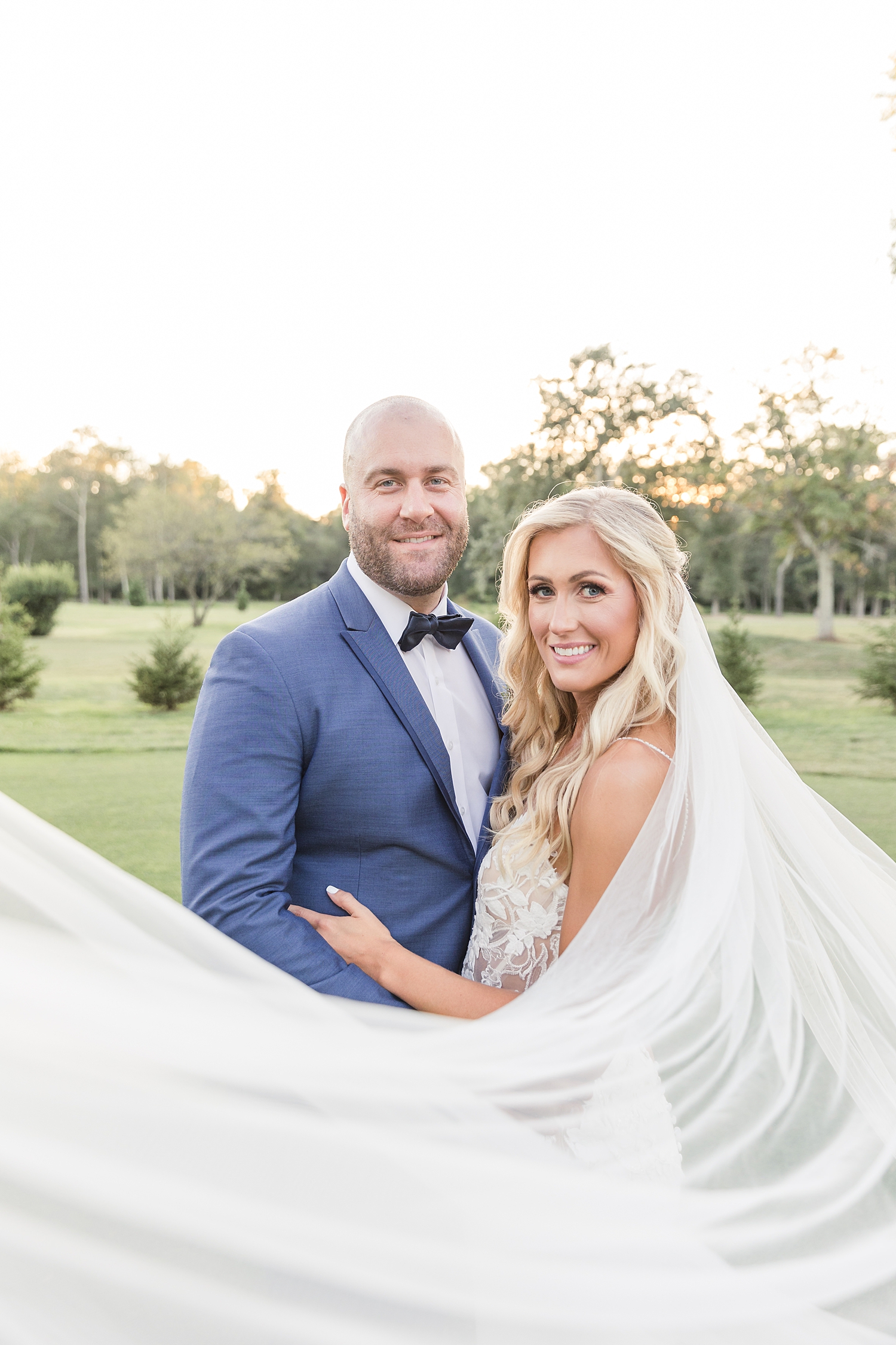 newlywed photos with bride's veil flowing around them