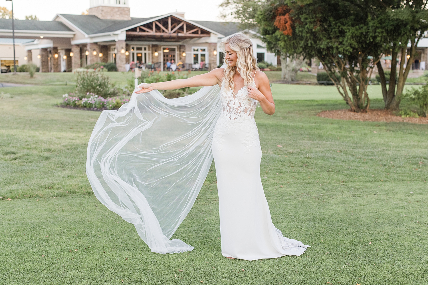 bride holds out her veil