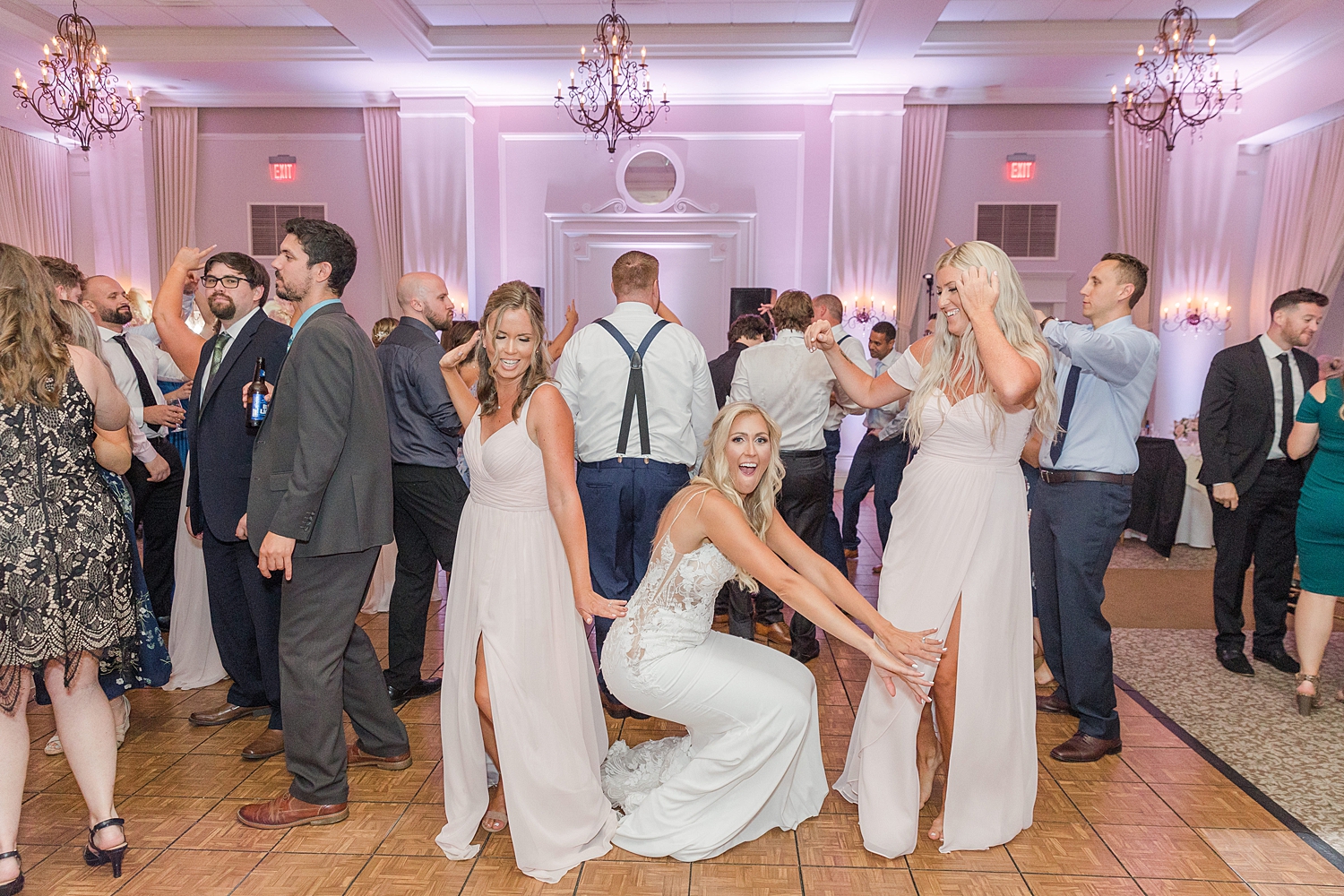 bride dances with bridesmaids