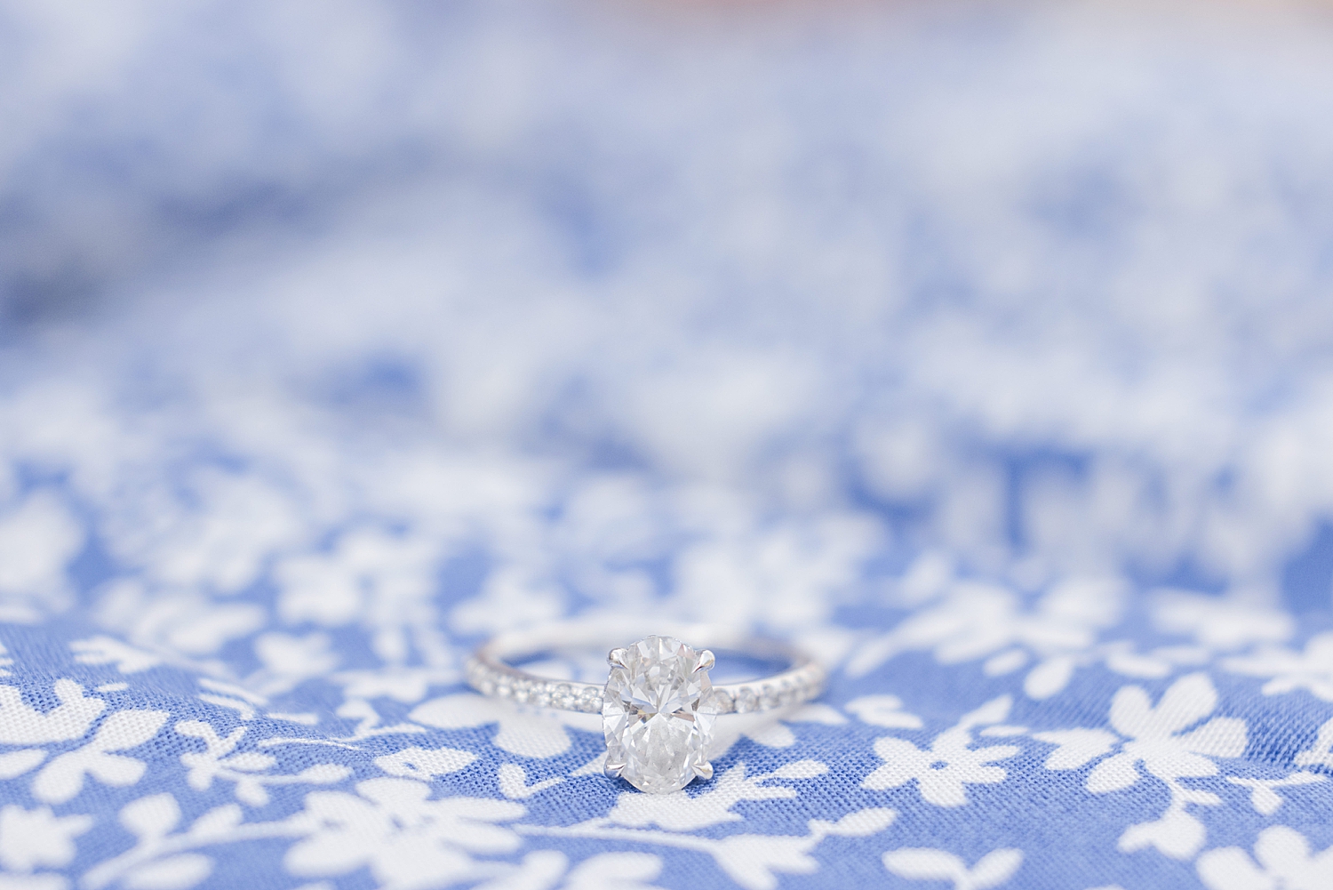 engagement ring on blue and white pattern